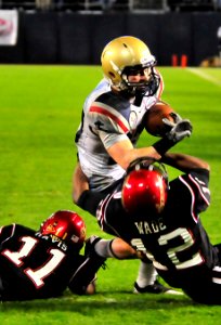 US Navy 101223-N-1722W-252 U.S. Naval Academy running back Bo Snelson (^23)is stopped by San Diego State University defensive backs Brandon Davis (