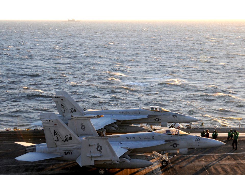US Navy 110126-N-7004H-330 Two F-A-18E Super Hornets prepare to take off aboard USS George H.W. Bush (CVN 77)