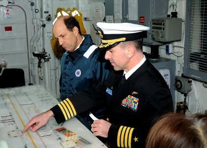 US Navy 110124-N-4743B-125 Capt. David Fluker, commanding officer of the forward-deployed amphibious assault ship USS Essex (LHD 2), explains the f