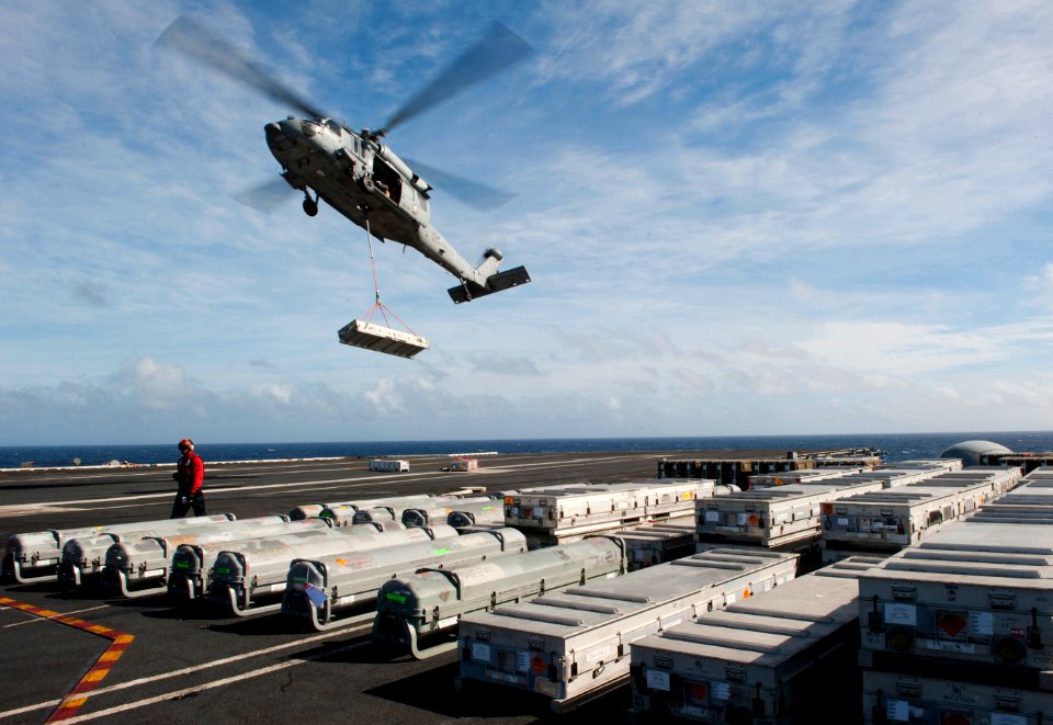 US Navy 101228-N-7981E-082 An MH-60S Sea Hawk helicopter delivers ordnance to USS Carl Vinson (CVN 70) during a vertical replenishment