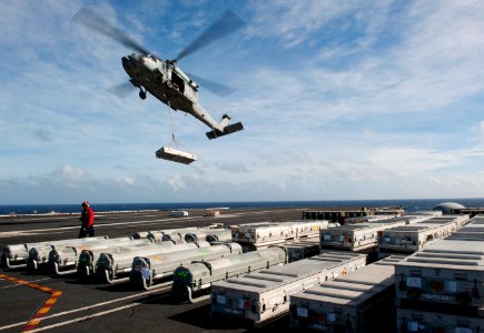 US Navy 101228-N-7981E-082 An MH-60S Sea Hawk helicopter delivers ordnance to USS Carl Vinson (CVN 70) during a vertical replenishment