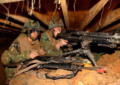 US Navy 110125-N-8816D-061 Seabees assigned to Naval Mobile Construction Battalion (NMCB) 133 man an M240B 7.62 mm machine gun in their fighting p
