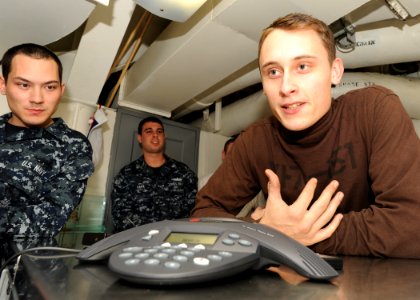 US Navy 101229-N-7095C-020 Aviation Structural Mechanic Airman Apprentice Robert Lamont asks Boston Bruins goalie Tim Thomas a question about the N