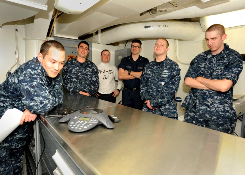 US Navy 101229-N-7095C-005 Sailors aboard the aircraft carrier USS Abraham Lincoln (CVN 72) speak with Boston Bruins goalie Tim Thomas during a pho