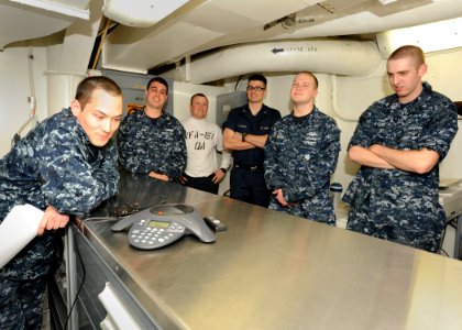 US Navy 101229-N-7095C-005 Sailors aboard the aircraft carrier USS Abraham Lincoln (CVN 72) speak with Boston Bruins goalie Tim Thomas during a pho