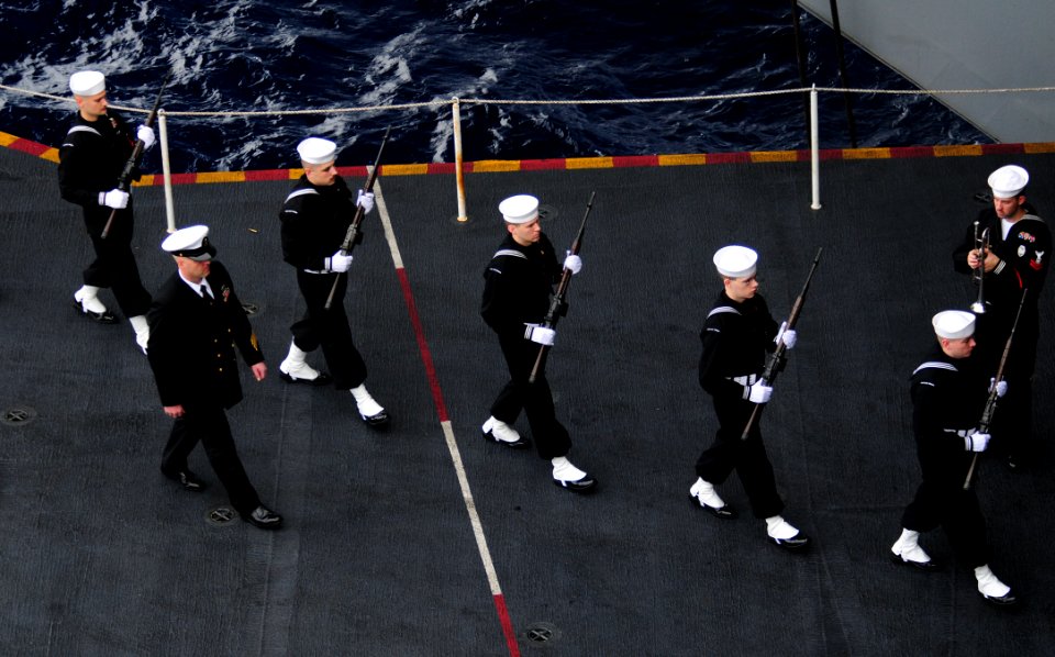 US Navy 101227-N-7488A-797 he rifle detail marches during a burial at sea aboard USS Carl Vinson (CVN 70)
