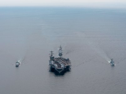 US Navy 110126-N-7981E-526 The Nimitz-class aircraft carrier USS Carl Vinson (CVN 70) leads the Royal Malaysian Navy frigate KD Lekir (FF 26) and c photo