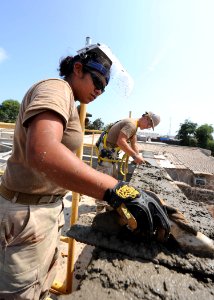 US Navy 110120-N-4440L-134 Builder Constructionman Diana Aceves, left, and Builder Constructionman Apprentice Robert Cox, both assigned to Naval Mo