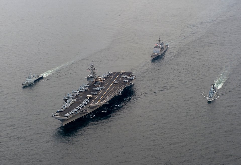 US Navy 110126-N-7981E-040 The Nimitz-class aircraft carrier USS Carl Vinson (CVN 70) leads the Royal Malaysian Navy frigate KD Lekir (FF 26) and c