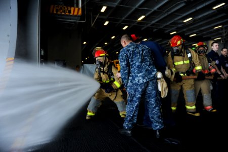 US Navy 110122-N-2475A-008 Sailors man a hose during damage control training aboard USS John C. Stennis (CVN 74)