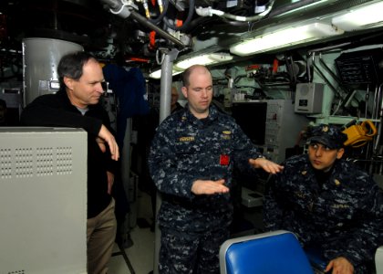 US Navy 101229-N-7705S-040 Lt. Cmdr. Robert Webster, engineering officer aboard the Los Angeles-class attack submarine USS Boise (SSN 764), explain photo