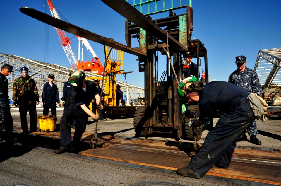 US Navy 101229-N-9626Y-049 Sailors perform maintenance on the catapults aboard the aircraft carrier USS George Washington (CVN 73)