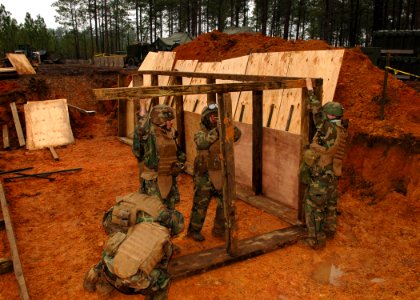 US Navy 110125-N-8816D-018 Seabees assigned to Naval Mobile Construction Battalion (NMCB) 133 build a heavy timber bunker during a field training e photo