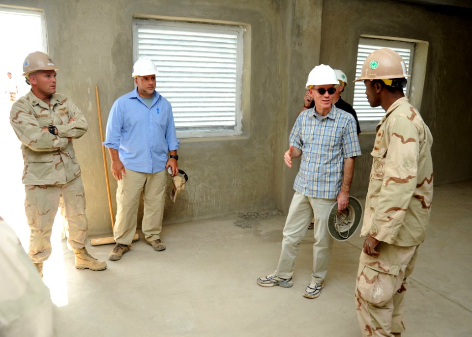 US Navy 110104-N-4440L-104 U.S. Ambassador to the Republic of Djibouti James C. Swan and Builder 2nd Class Jermaine Blake discuss building details