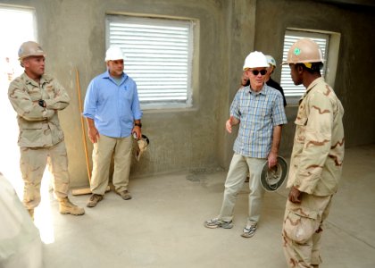 US Navy 110104-N-4440L-104 U.S. Ambassador to the Republic of Djibouti James C. Swan and Builder 2nd Class Jermaine Blake discuss building details photo