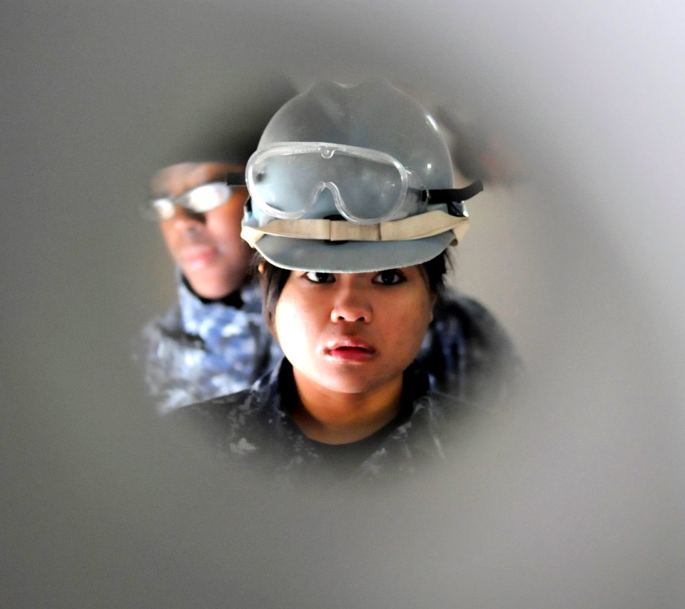 US Navy 110128-N-0864H-303 Boatswain's Mate 2nd Class Kelly Chan stands watch as the petty officer in charge of a mooring line during sea and ancho
