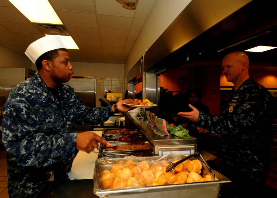 US Navy 110128-N-1092P-111 Culinary Specialist 3rd Class Justin Allen serves Naval Station Norfolk Command Master Chief David B. Carter at the base