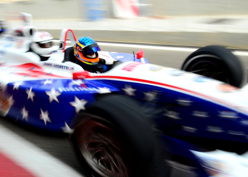 US Navy 110116-N-6499D-230 Jeff Sinden, driver and co-owner of the modified Dallara IZOD IndyCar Series two-seat race car, takes a military member