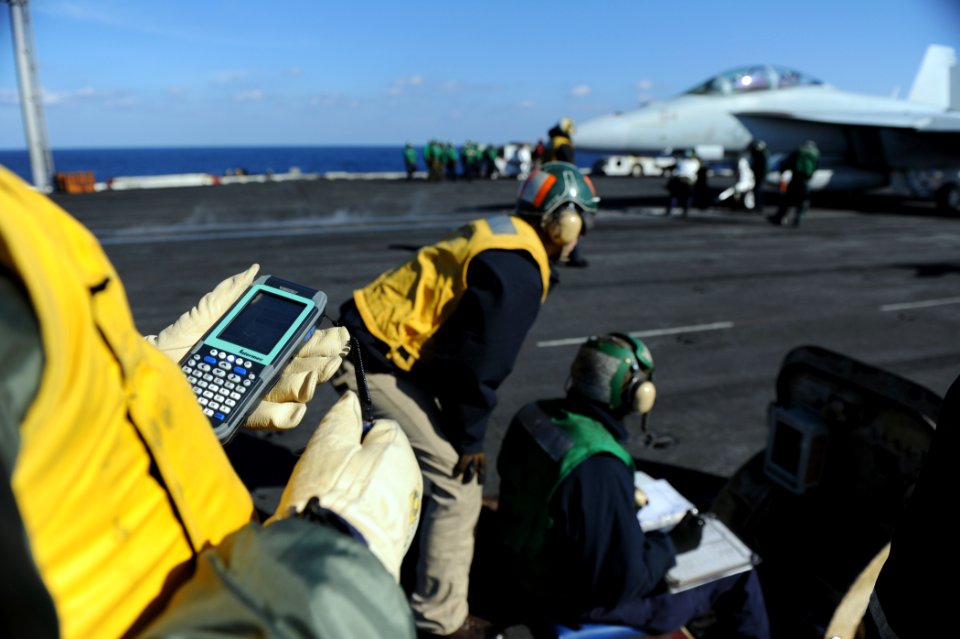 US Navy 110128-N-7676W-097 A shooter, center, aboard the aircraft carrier USS Harry S. Truman (CVN 75) verifies the catapult selector valve (CSV) s