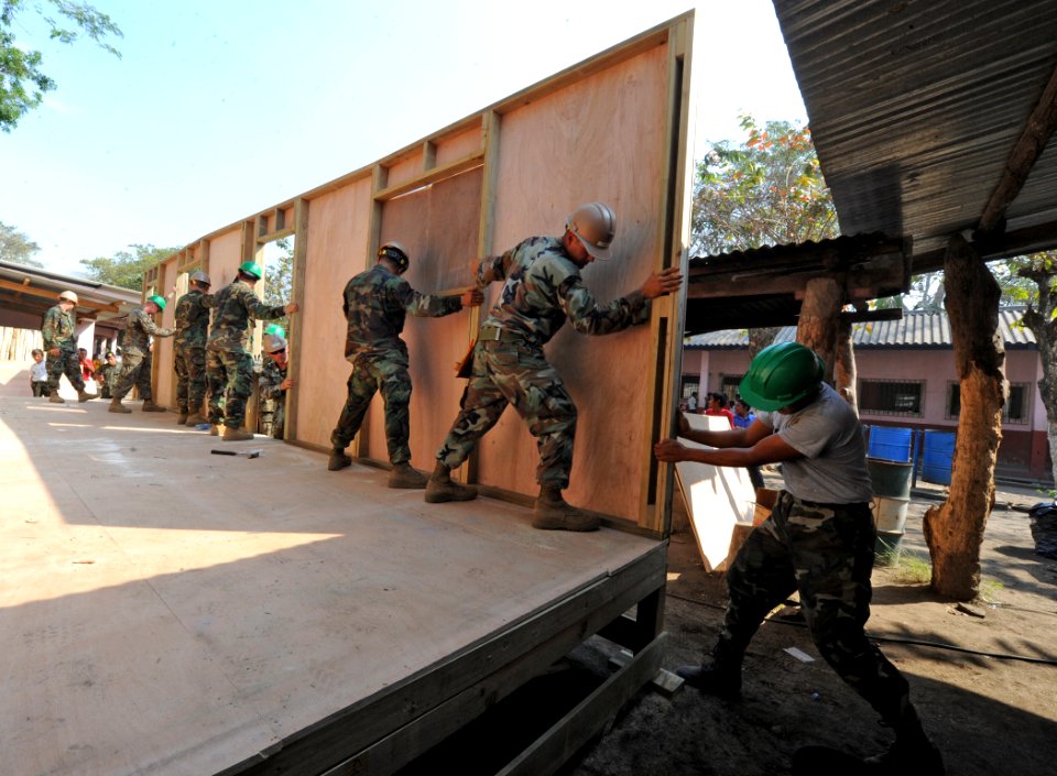 US Navy 110124-N-7589W-031 Sailors assigned to Naval Mobile Construction Battalion (NMCB) 28 and Marines with 2nd Marine Logistics Group raise a wa