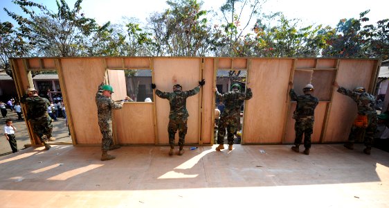 US Navy 110124-N-7589W-018 Sailors assigned to Naval Mobile Construction Battalion (NMCB) 28 and Marines with 2nd Marine Logistics Group raise a wa photo