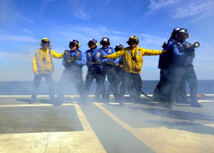 US Navy 110130-N-3374C-281 Sailors aboard the aircraft carrier USS George H.W. Bush (CVN 77) simulate extinguishing a fire during a mass casualty d