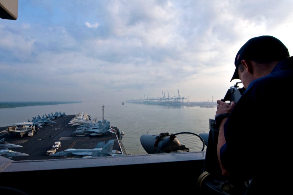 US Navy 110122-N-7488A-377 Operations Specialist Seaman Patrick Palkowski stands a lookout watch as the Nimitz-class aircraft carrier USS Carl Vins