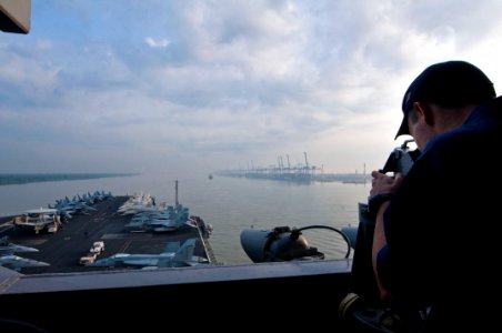 US Navy 110122-N-7488A-377 Operations Specialist Seaman Patrick Palkowski stands a lookout watch as the Nimitz-class aircraft carrier USS Carl Vins