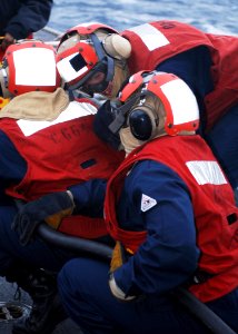 US Navy 110126-N-2686K-027 Sailors simulate fighting a fire during a damage control training exercise on the flight deck aboard the guided-missile photo