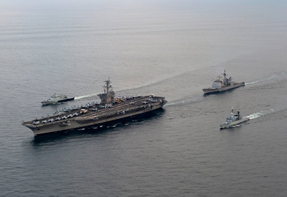 US Navy 110126-N-7981E-018 The Nimitz-class aircraft carrier USS Carl Vinson (CVN 70) leads the Royal Malaysian Navy frigate KD Lekir (FF 26) and c