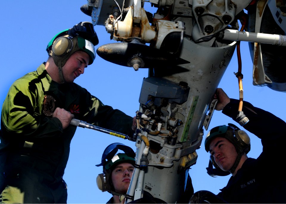 US Navy 110201-N-3154P-052 Service members tighten the tension straps on an MV-22B Osprey engine aboard the amphibious assault ship USS Kearsarge (