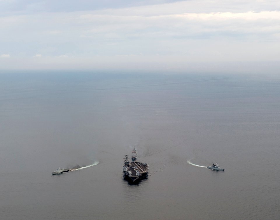US Navy 110126-N-7981E-229 The Royal Malaysian Navy frigate KD Lekir (FF 26) and corvette KD Kelantan (FFL 175) break away from the Nimitz-class ai
