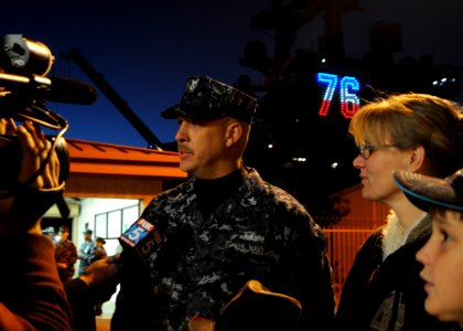 US Navy 110202-N-3178C-027 Hull Technician 1st Class Michael Hirt nd his family are interviewed by a local television news reporter in front of USS