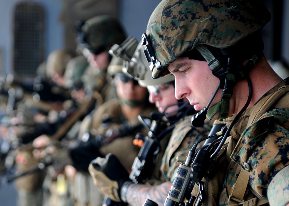 US Navy 110202-N-4743B-115 Marines check their weapons during a call-away drill in the hangar bay of USS Essex (LHD 2)