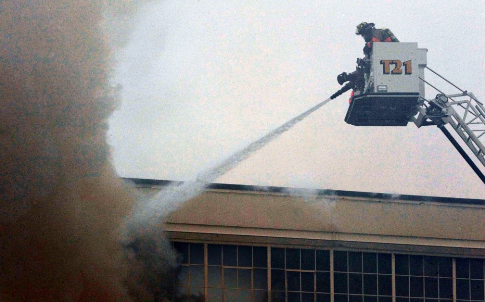 US Navy 110127-N-5319A-006 Firefighters work to put out a warehouse fire at Naval Station Norfolk
