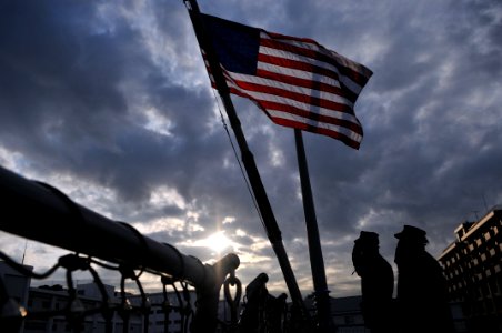 US Navy 110202-N-9818V-017 Chief Fire Controlman Brandin Singletary and Operations Specialist 2nd Class Dorothy Barnett salute the national ensign