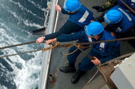 US Navy 110126-N-9589S-099 Sailors heave a line during an underway replenishment aboard USS Truxtun (DDG 103) photo