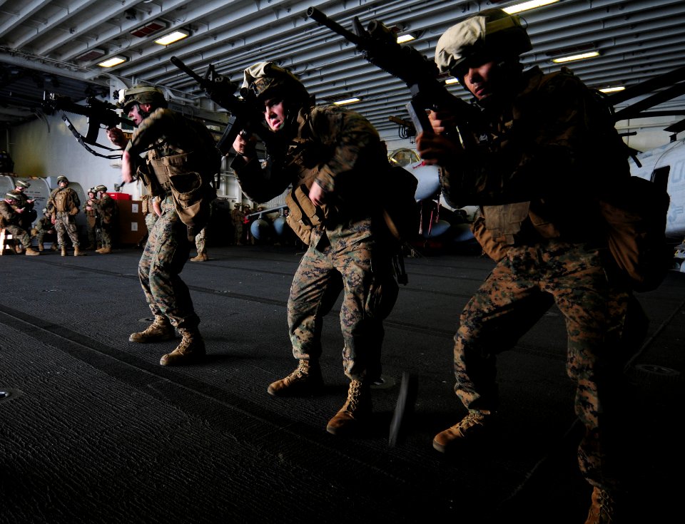 US Navy 110203-N-5538K-096 Marines assigned to the 31st Marine Expeditionary Unit participate in small-arms weapons training in the hangar bay of t