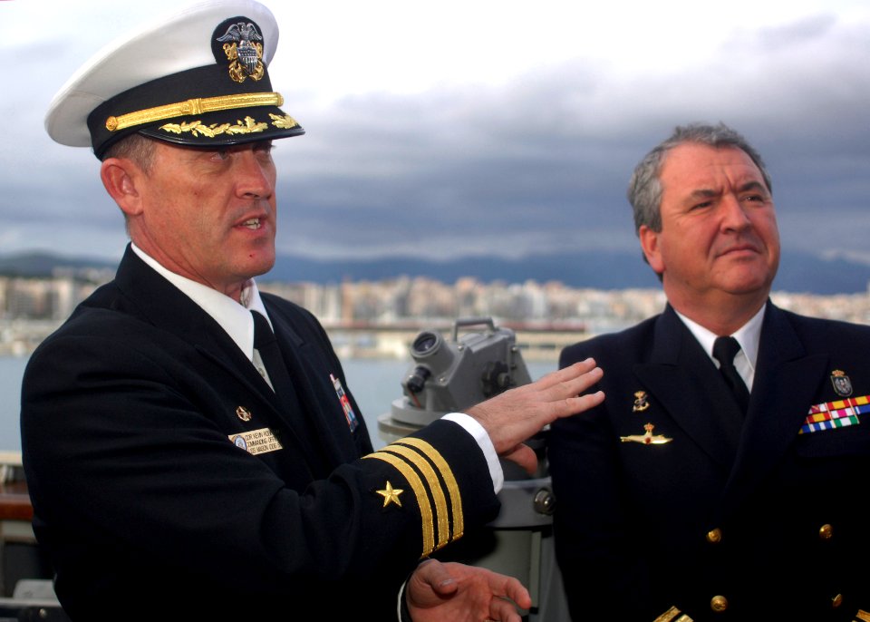 US Navy 110128-N-5838W-013 Cmdr. Kevin M. Robinson gives Spanish service members and police officers a tour of USS Mason (DDG 87)