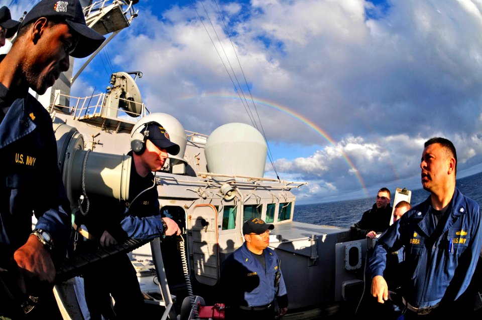 US Navy 110203-N-9811S-095 Cmdr. A.H. Ibarra, right, commanding officer of the guided-missile destroyer USS Barry (DDG 52), discusses tactics and p