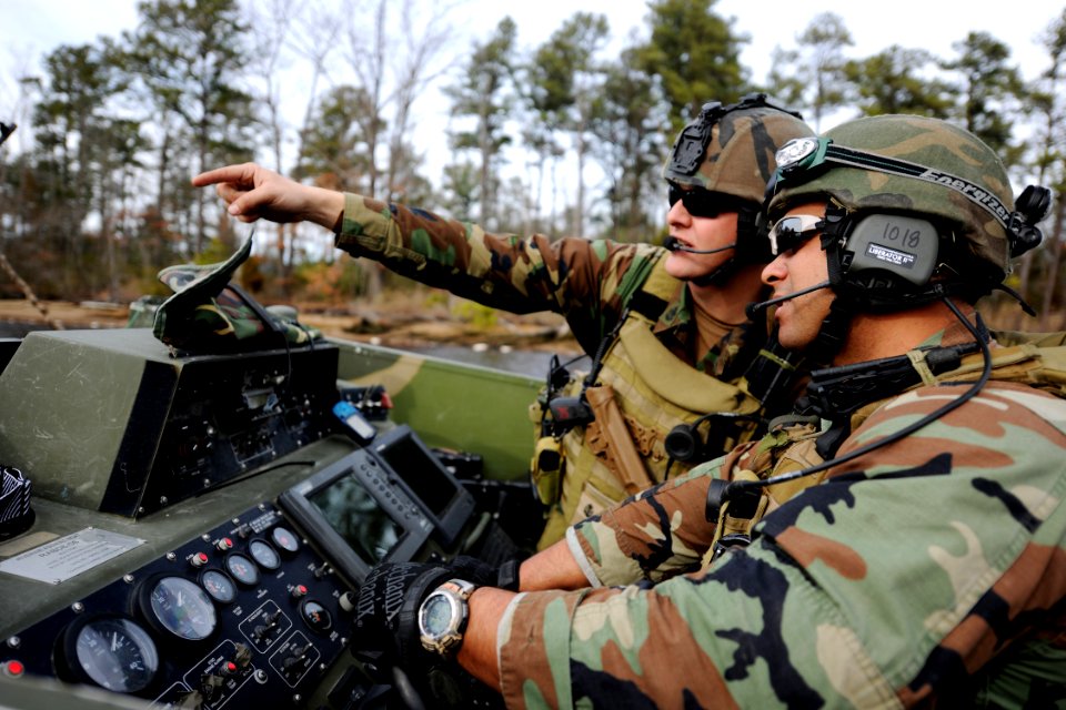 US Navy 110202-N-YO394-236 Sailors ook for a place to insert a ground patrol during a final exam problem exercise