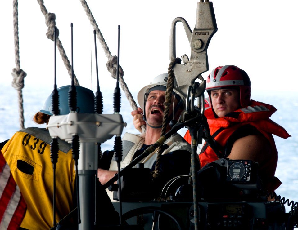 US Navy 110131-N-2953W-353 Senior Chief Boatswain's Mate Thomas Hengel, center, directs Sailors during the return to USS Carl Vinson (CVN 70)
