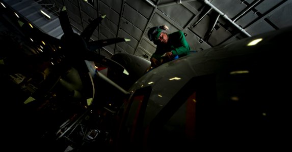 US Navy 110131-N-2055M-182 Aviation Structural Mechanic Airman Gerardo Santiago prepares an E-2C Hawkeye for painting aboard USS Carl Vinson (CVN 7