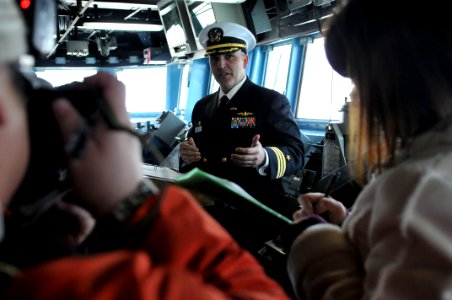 US Navy 110204-N-9818V-103 Cmdr. Dennis Velez, commanding officer of the guided-missile destroyer USS Fitzgerald (DDG 62), answers questions from m photo