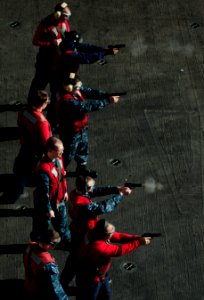 US Navy 110201-N-2055M-212 Sailors fire 9mm service pistols during a weapons qualification aboard USS Carl Vinson (CVN 70)