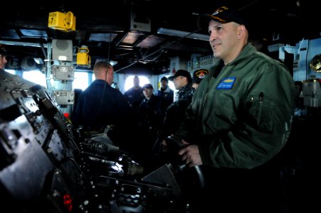 US Navy 110203-N-9818V-091 Cmdr. Dennis Velez, commanding officer of the guided-missile destroyer USS Fitzgerald (DDG 62), mans the helm photo