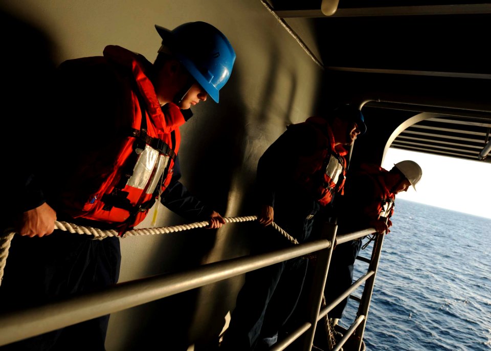 US Navy 110129-N-3374C-191 Sailors hold a line during rigid-hull inflatable boat training operations aboard USS George H.W. Bush (CVN 77)