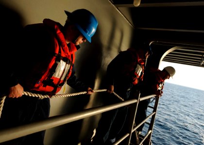 US Navy 110129-N-3374C-191 Sailors hold a line during rigid-hull inflatable boat training operations aboard USS George H.W. Bush (CVN 77)