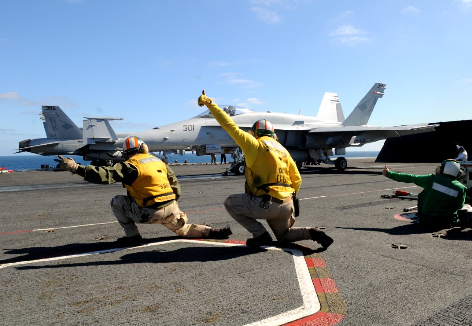 US Navy 110204-N-4590G-233 Lt. Preston Rackauskas and Lt. Bryan Bennett shoot an F-A-18C Hornet aboard USS Ronald Reagan (CVN 76)