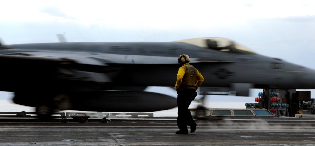 US Navy 110131-N-3374C-068 A Sailor assigned to the air department aboard the aircraft carrier USS George H.W. Bush (CVN 77) watches an F-A-18E Sup
